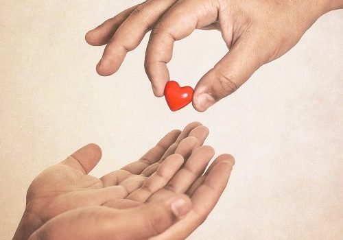 Share your love (hand giving a heart in vintage style)